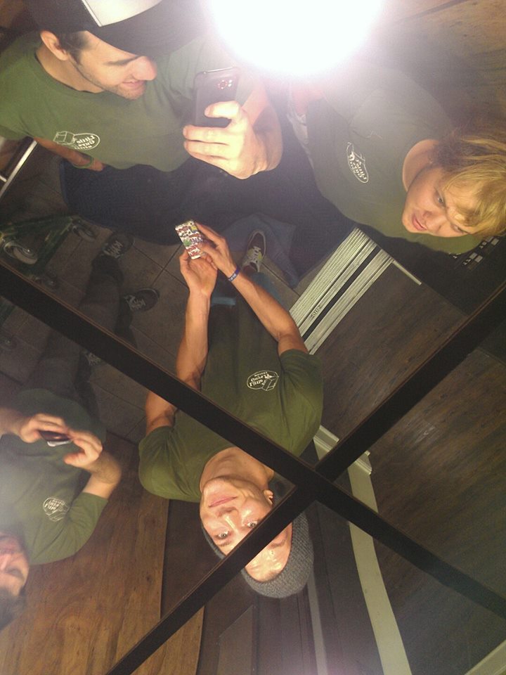 Little Guys Movers in Lexington, Kentucky  pause for a Kodak moment in an elevator with a mirrored ceiling.