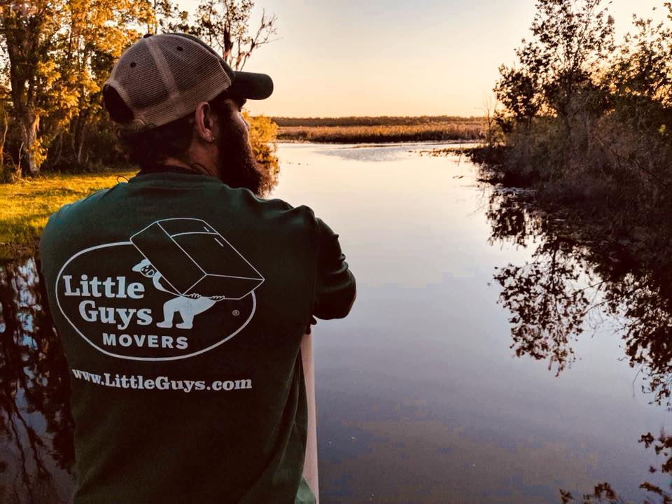 careers in raleigh man looking at lake in Little Guys Movers shirt