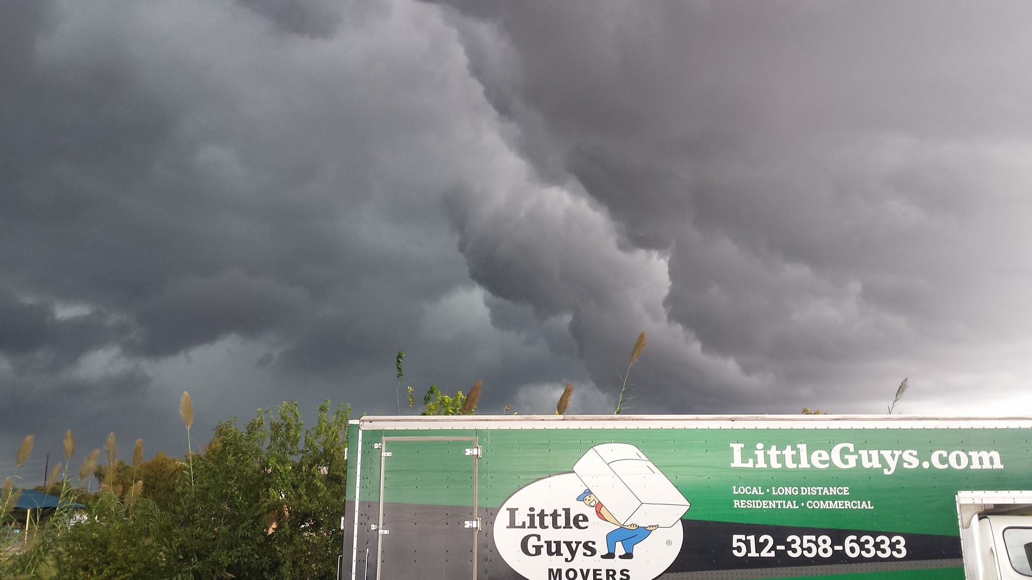 austin moving truck with rain clouds