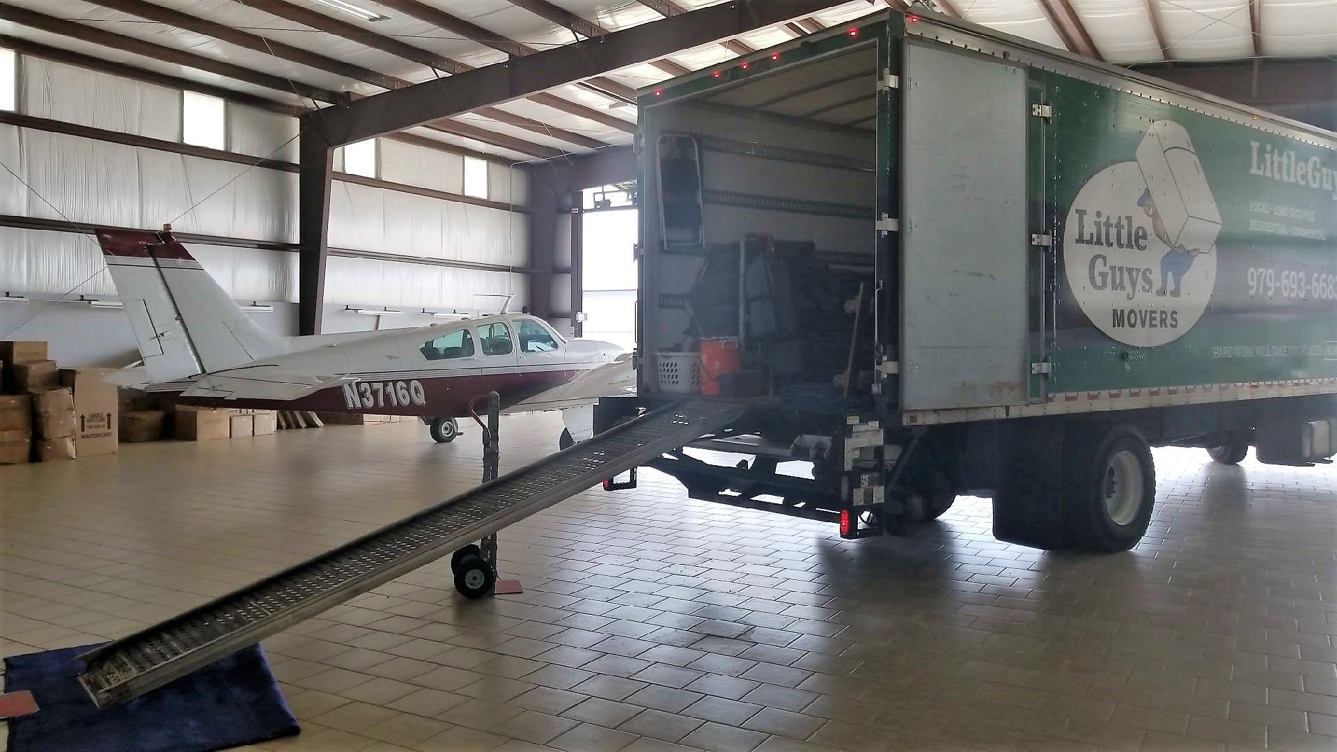 college station moving truck in aircraft hangar