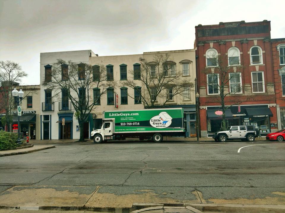 wilmington commercial movers little guys movers truck in front of main street businesses
