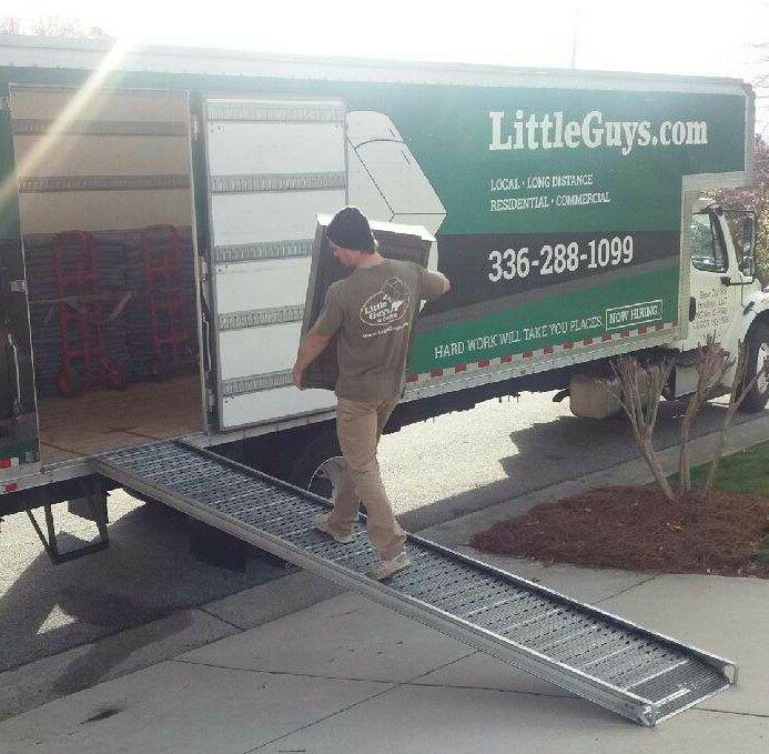 greensboro moving van with mover carrying furniture