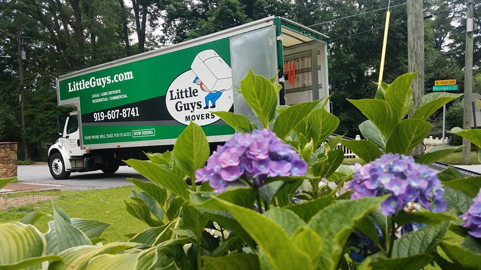 raleigh summer moving truck outside with flowers