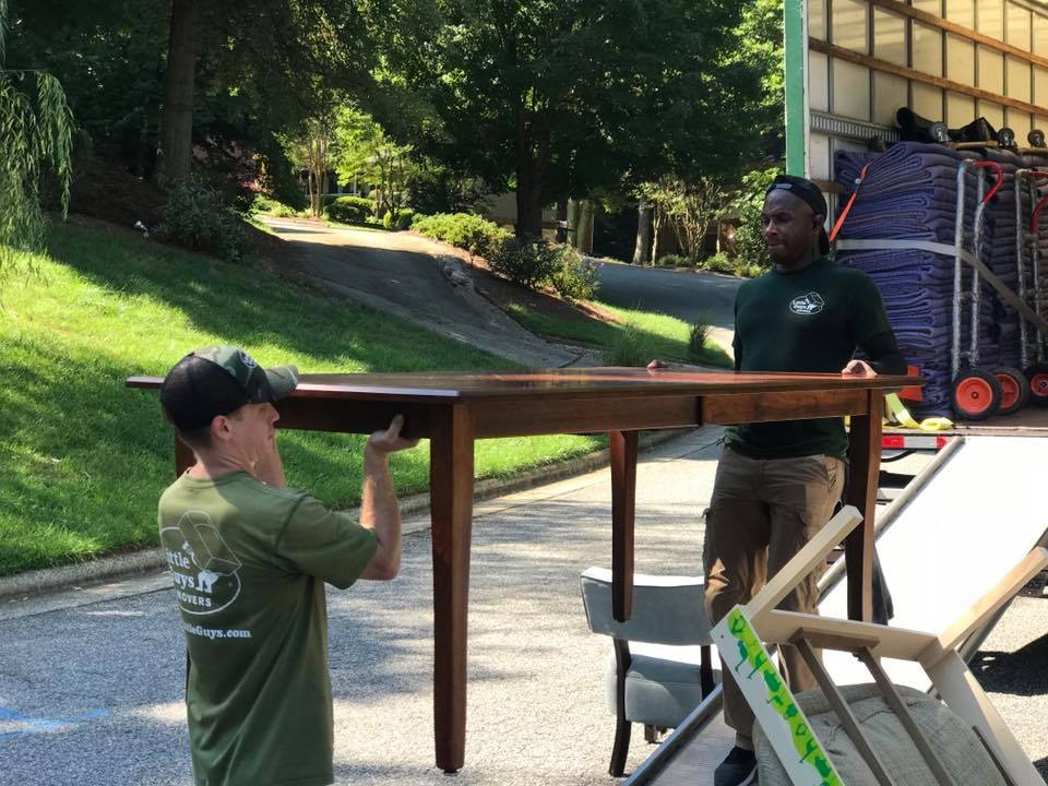 little guys movers greensboro carrying a table