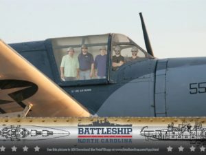 Members from the Little Guys Movers franchise location scout team pose for a picture on the USS North Carolina Battleship in Wilmington, NC